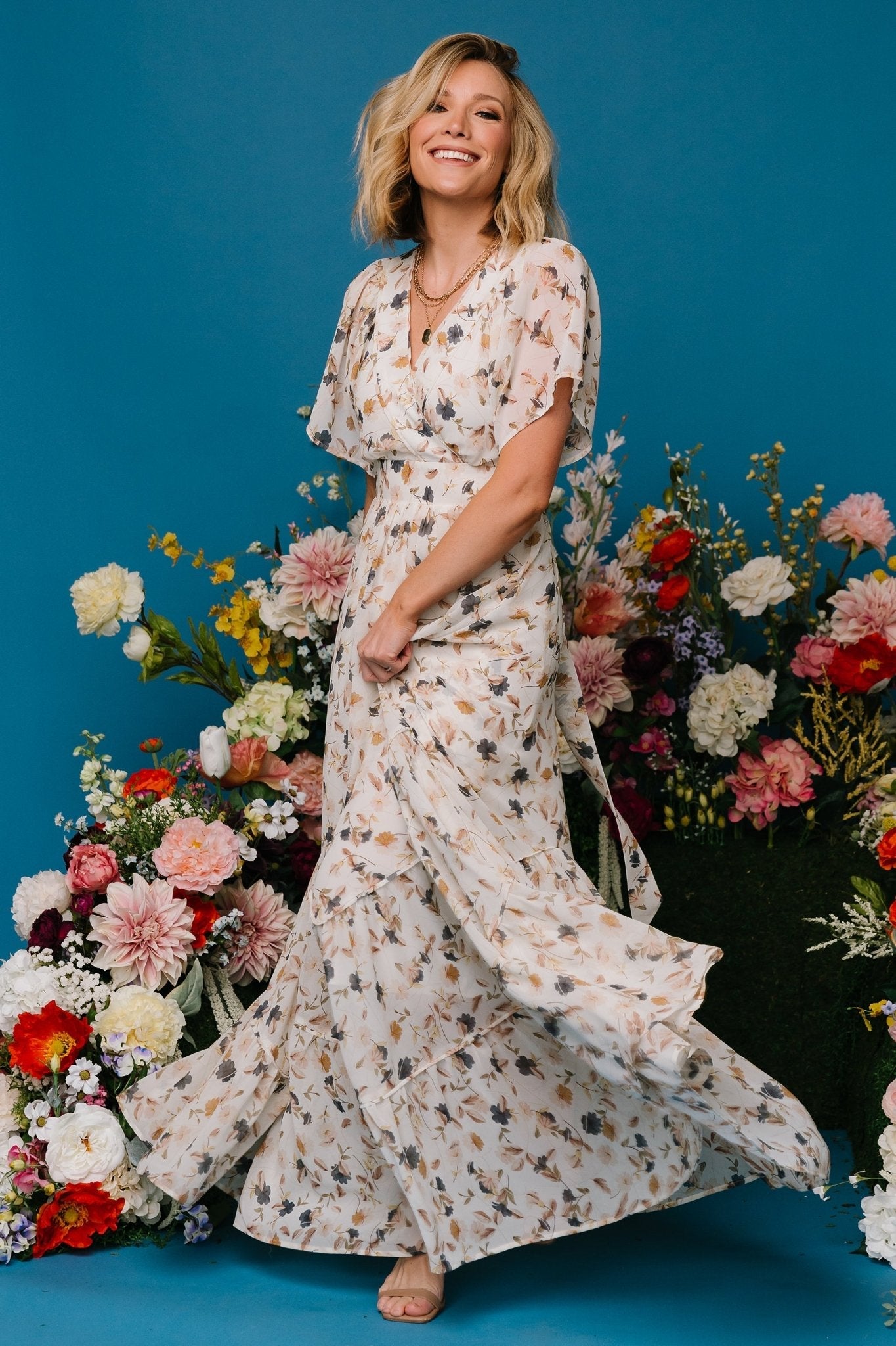 Front view of Katherine maxi dress in cream multi floral; chiffon overlay, surplice neckline, flutter sleeves.
